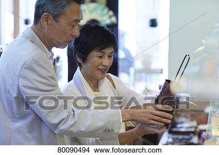 Picture - Japanese senior couple shopping. Fotosearch