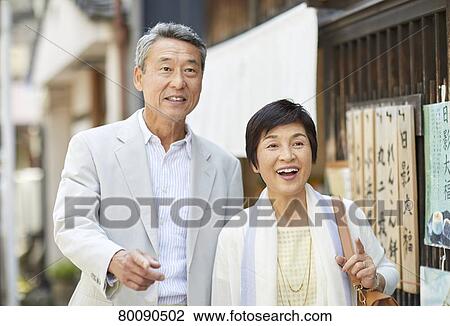 Stock Image - Japanese senior couple shopping. Fotosearch