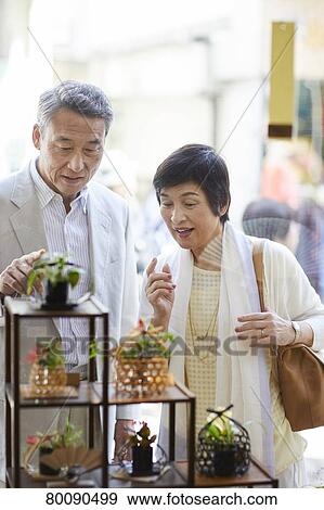 Stock Photo - Japanese senior couple shopping. Fotosearch