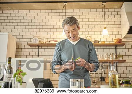 Japanese senior man in the kitchen View Large Photo Image Stock Photo - Japanese senior man in the kitchen. Fotosearch