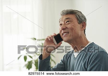 Picture - Japanese senior man on the sofa. Fotosearch