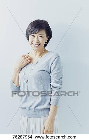 Japanese senior woman against white wall View Large Photo Image Picture - Japanese senior woman against white wall. Fotosearch