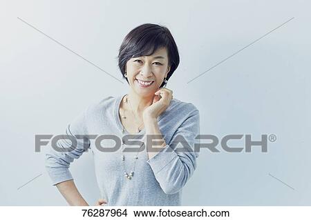 Japanese senior woman against white wall View Large Photo Image Picture - Japanese senior woman against white wall. Fotosearch
