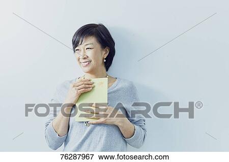 Japanese senior woman against white wall View Large Photo Image Stock Photo - Japanese senior woman against white wall. Fotosearch
