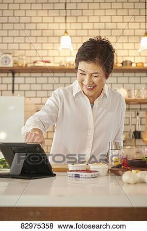 Japanese senior woman in the kitchen View Large Photo Image Stock Photo - Japanese senior woman in the kitchen. Fotosearch
