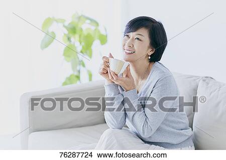 Japanese senior woman on sofa View Large Photo Image Picture - Japanese senior woman on sofa. Fotosearch