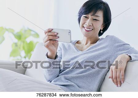 Japanese senior woman on sofa View Large Photo Image Picture - Japanese senior woman on sofa. Fotosearch