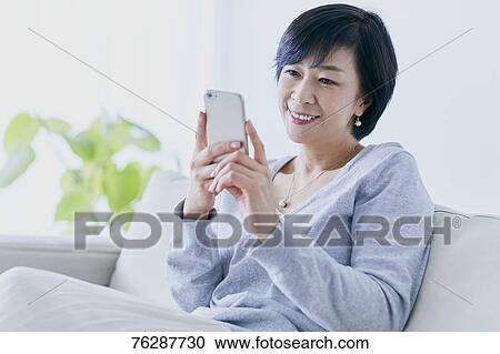 Japanese senior woman on sofa View Large Photo Image Stock Image - Japanese senior woman on sofa. Fotosearch