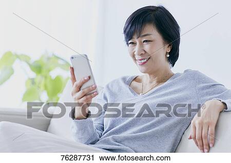 Japanese senior woman on sofa View Large Photo Image Stock Image - Japanese senior woman on sofa. Fotosearch