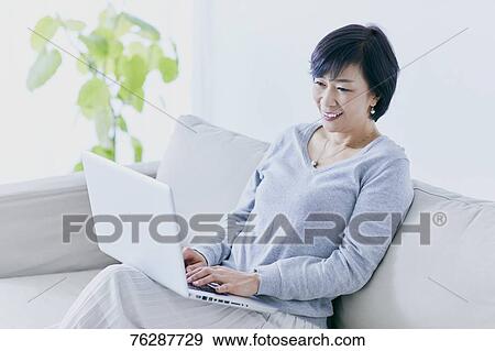Japanese senior woman on sofa View Large Photo Image Stock Photo - Japanese senior woman on sofa. Fotosearch