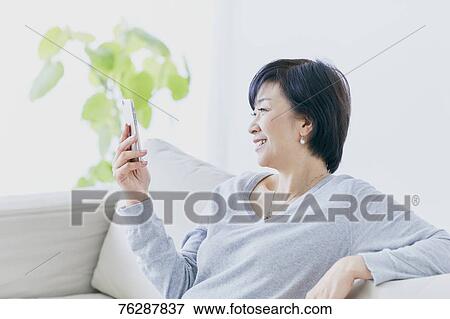 Japanese senior woman on sofa View Large Photo Image Stock Photo - Japanese senior woman on sofa. Fotosearch