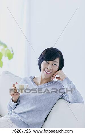 Japanese senior woman on sofa View Large Photo Image Stock Photograph - Japanese senior woman on sofa. Fotosearch