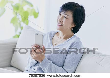 Japanese senior woman on sofa View Large Photo Image Stock Photograph - Japanese senior woman on sofa. Fotosearch