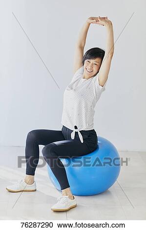 Stock Image - Japanese senior woman training. Fotosearch