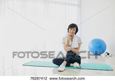 Stock Image - Japanese senior woman training. Fotosearch