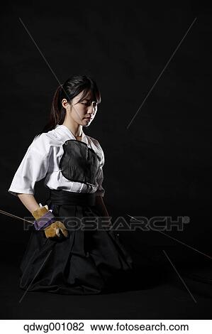 Stock Image - Japanese traditional archery athlete against black background. Fotosearch