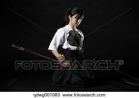 Stock Image - Japanese traditional archery athlete against black background. Fotosearch