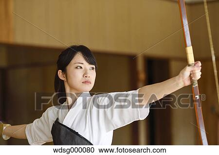 Stock Image - Japanese traditional archery athlete practicing. Fotosearch