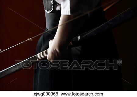 Japanese traditional archery athlete hand holding bow View Large Photo Image Stock Photo - Japanese traditional archery athlete hand holding bow. Fotosearch