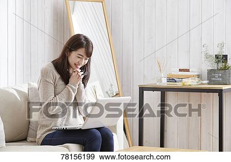 Japanese woman buying online View Large Photo Image Stock Photo - Japanese woman buying online. Fotosearch