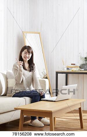 Stock Photo - Japanese woman buying online. Fotosearch