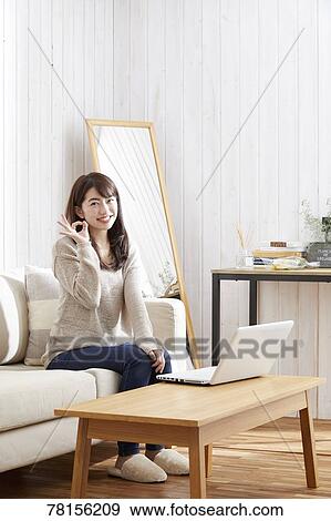 Stock Photo - Japanese woman buying online. Fotosearch