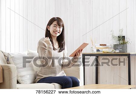 Stock Photo - Japanese woman buying online. Fotosearch