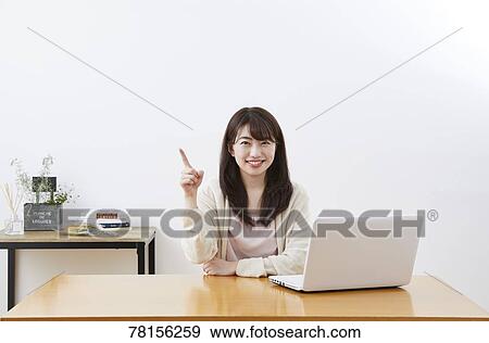 Stock Photo - Japanese woman buying online. Fotosearch