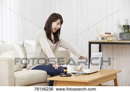 Stock Photograph - Japanese woman buying online. Fotosearch