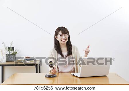 Stock Photograph - Japanese woman buying online. Fotosearch