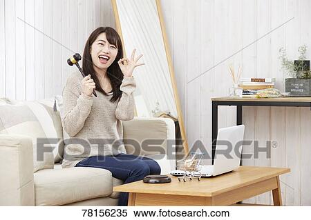 Stock Photography - Japanese woman buying online. Fotosearch