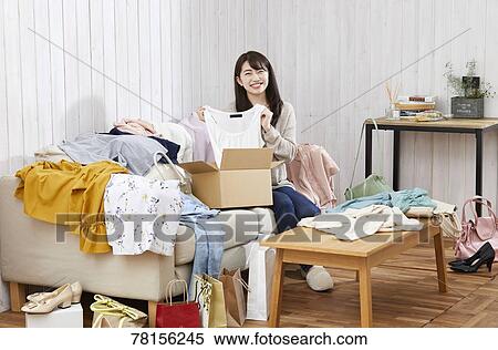 Stock Photography - Japanese woman buying online. Fotosearch