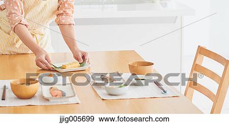 Japanese woman cooking in the kitchen View Large Photo Image Stock Photo - Japanese woman cooking in the kitchen. Fotosearch
