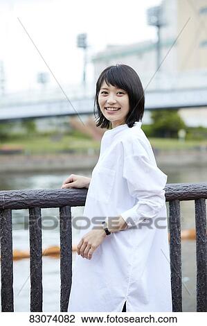 Stock Image - Japanese woman downtown Tokyo. Fotosearch