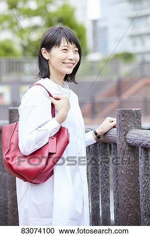 Stock Image - Japanese woman downtown Tokyo. Fotosearch