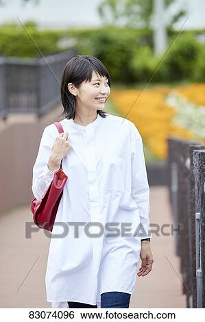 Stock Photograph - Japanese woman downtown Tokyo. Fotosearch