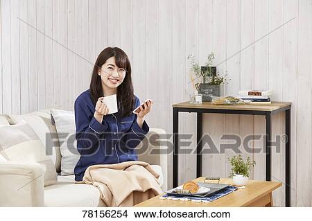 Japanese woman eating in a pajamas View Large Photo Image Picture - Japanese woman eating in a pajamas. Fotosearch
