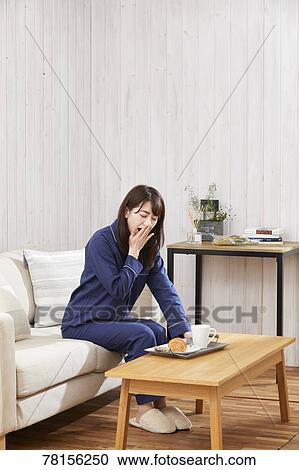 Japanese woman eating in a pajamas View Large Photo Image Stock Image - Japanese woman eating in a pajamas. Fotosearch