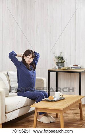 Japanese woman eating in a pajamas View Large Photo Image Stock Image - Japanese woman eating in a pajamas. Fotosearch