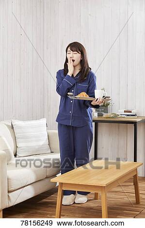 Japanese woman eating in a pajamas View Large Photo Image Stock Photo - Japanese woman eating in a pajamas. Fotosearch