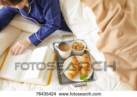 Japanese woman having breakfast in bed View Large Photo Image Picture - Japanese woman having breakfast in bed. Fotosearch