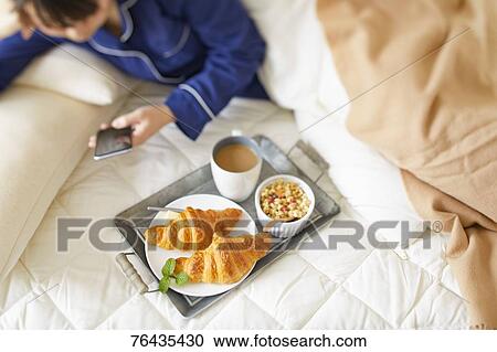 Japanese woman having breakfast in bed View Large Photo Image Stock Image - Japanese woman having breakfast in bed. Fotosearch