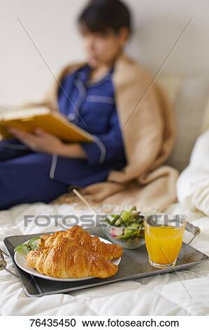 Japanese woman having breakfast in bed View Large Photo Image Stock Image - Japanese woman having breakfast in bed. Fotosearch
