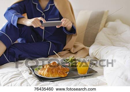 Japanese woman having breakfast in bed View Large Photo Image Stock Image - Japanese woman having breakfast in bed. Fotosearch