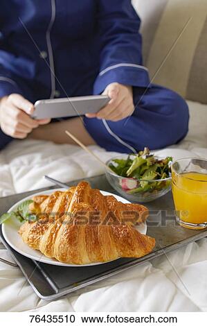 Japanese woman having breakfast in bed View Large Photo Image Stock Image - Japanese woman having breakfast in bed. Fotosearch
