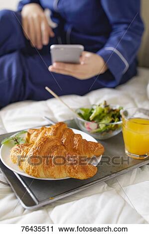 Japanese woman having breakfast in bed View Large Photo Image Stock Image - Japanese woman having breakfast in bed. Fotosearch