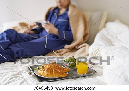 Japanese woman having breakfast in bed View Large Photo Image Stock Photo - Japanese woman having breakfast in bed. Fotosearch