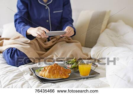 Japanese woman having breakfast in bed View Large Photo Image Stock Photograph - Japanese woman having breakfast in bed. Fotosearch