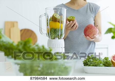 Japanese woman making smoothie in the kitchen View Large Photo Image Picture - Japanese woman making smoothie in the kitchen. Fotosearch
