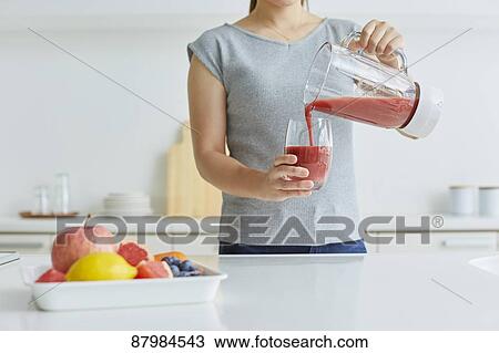 Japanese woman making smoothie in the kitchen View Large Photo Image Stock Image - Japanese woman making smoothie in the kitchen. Fotosearch